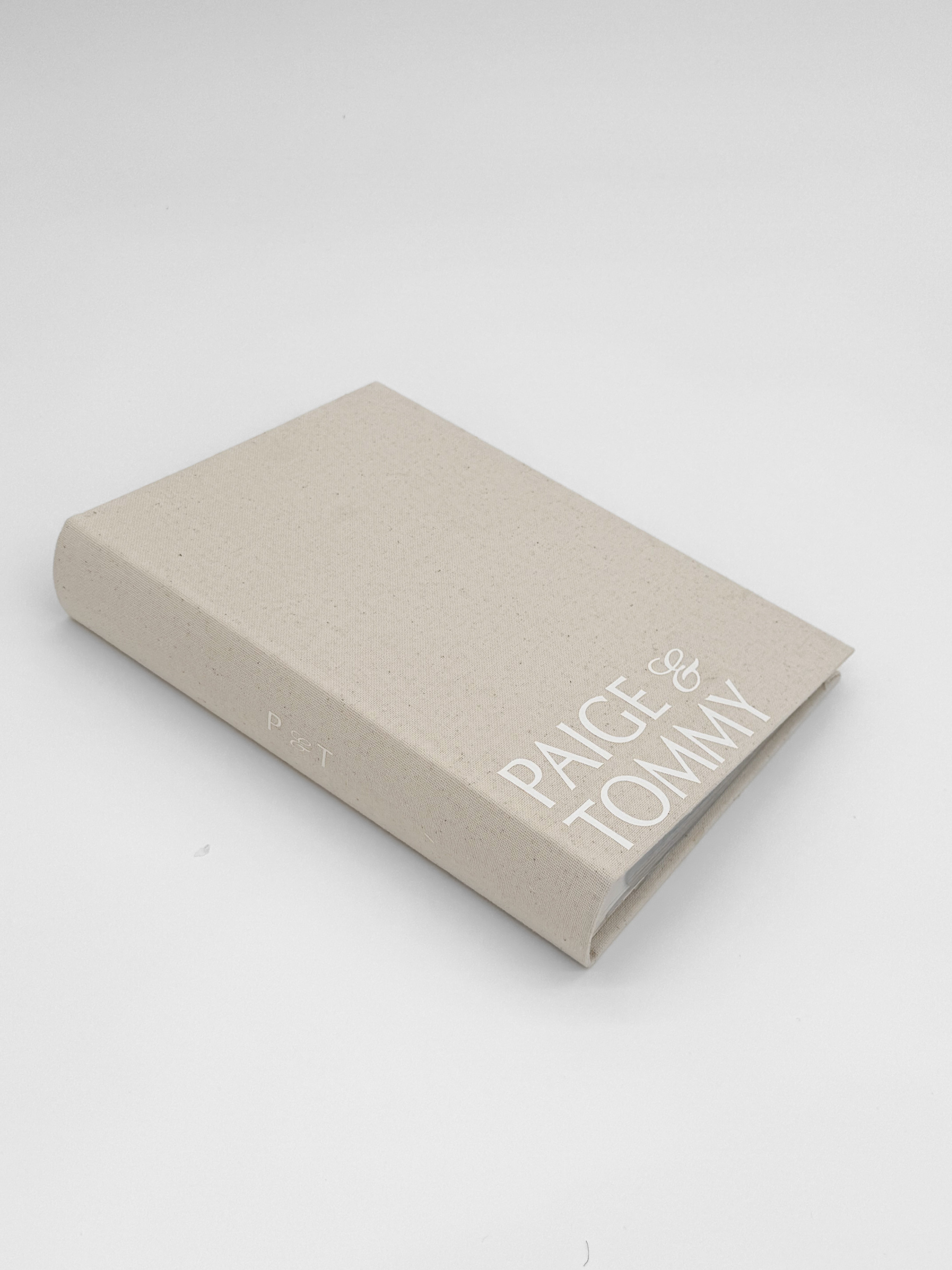 Personalized wedding photo album with custom couple names on linen cover for modern brides